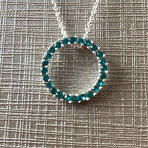 Silver tone necklace with turquoise round pendant
